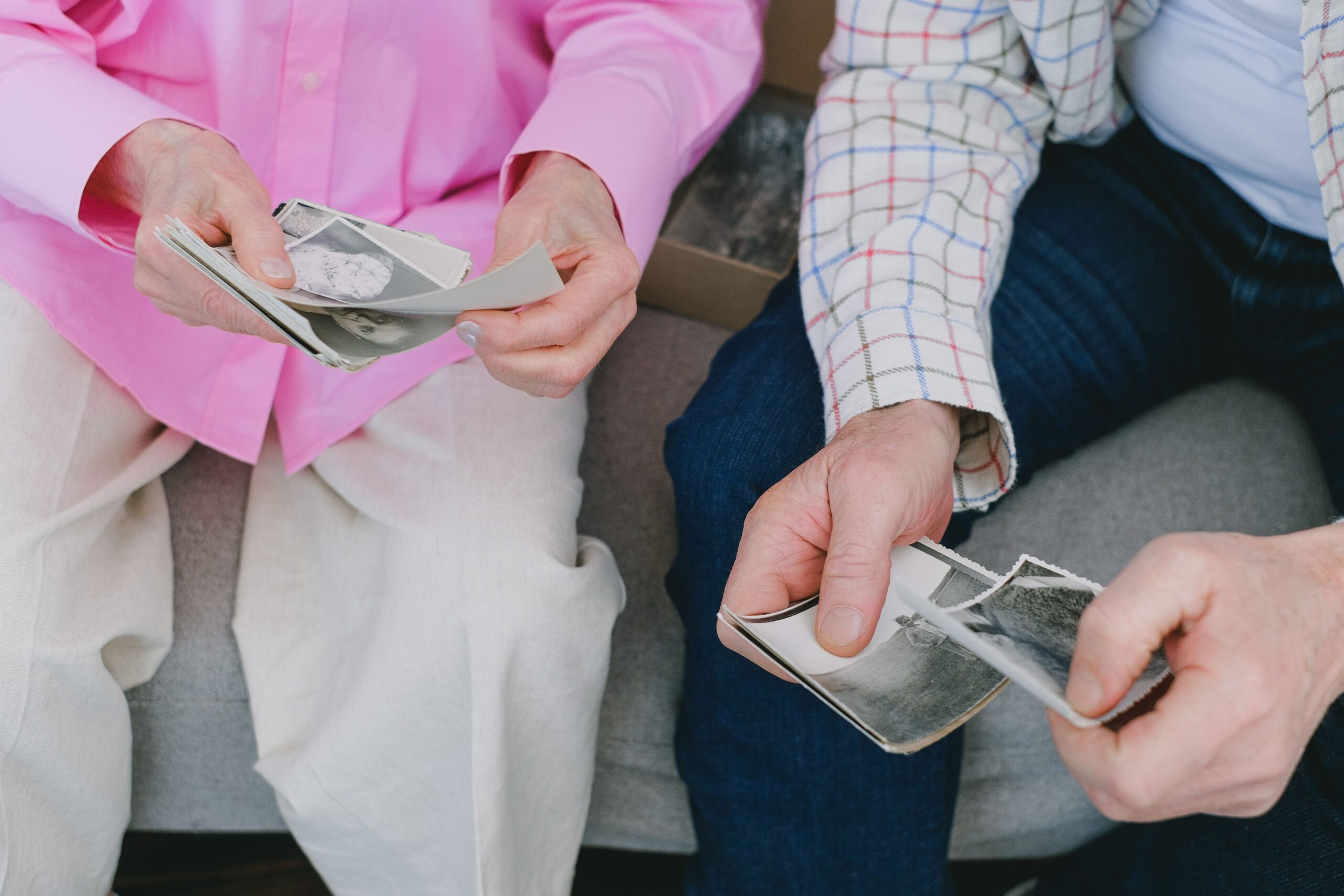 Two people sorting through old family photographs.