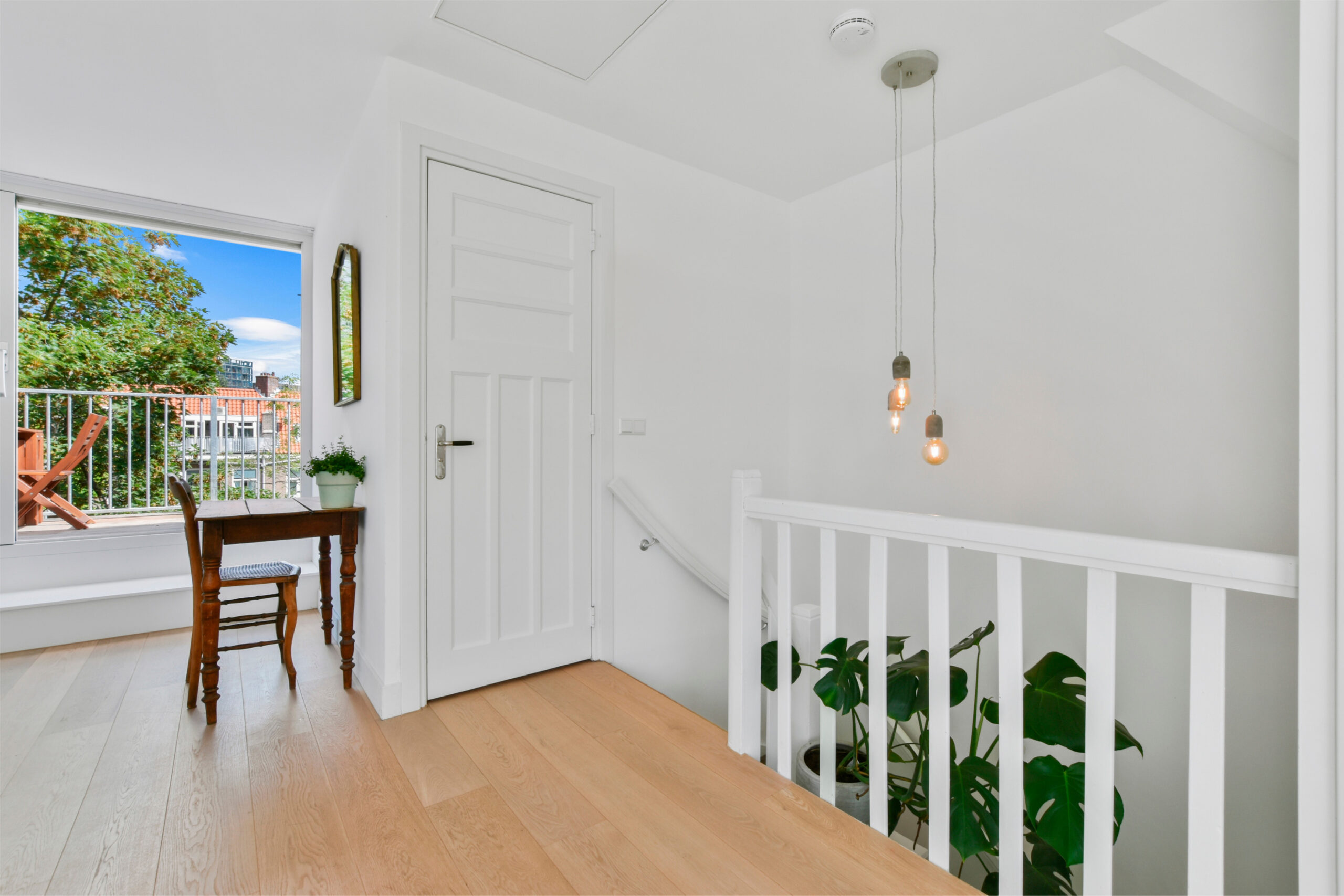 A bright, organized hallway with a clear walkway and natural light.
